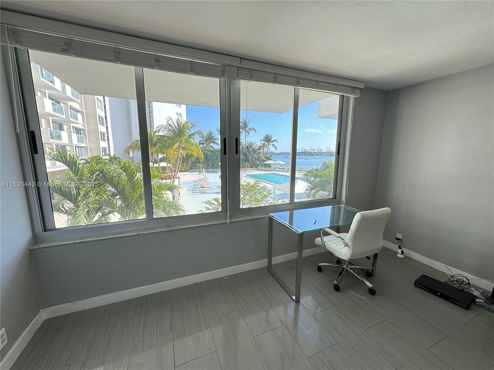 1200 West Avenue, Unit 202 Miami Beach, FL 33139 - Photo 3 of 45 a view of a room with a large window and sitting area