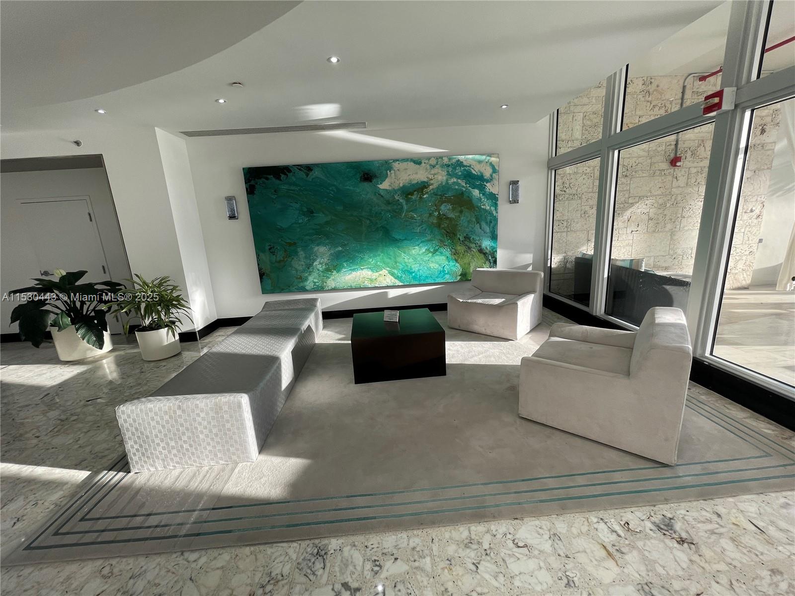 1200 West Avenue, Unit 202 Miami Beach, FL 33139 - Photo 32 of 45 a living room with furniture and a flat screen tv