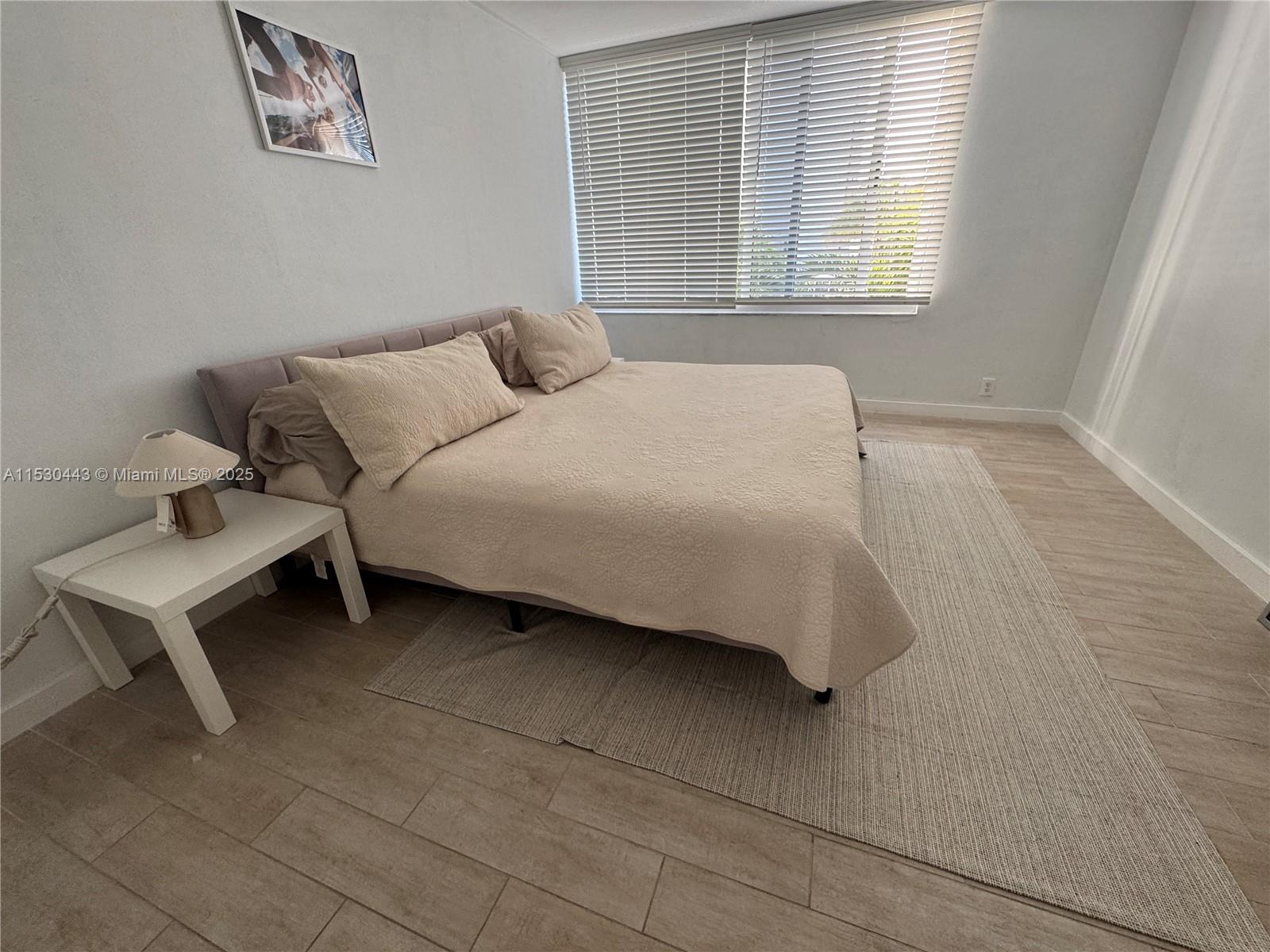 1200 West Avenue, Unit 202 Miami Beach, FL 33139 - Photo 40 of 45 a bedroom with a bed and a window