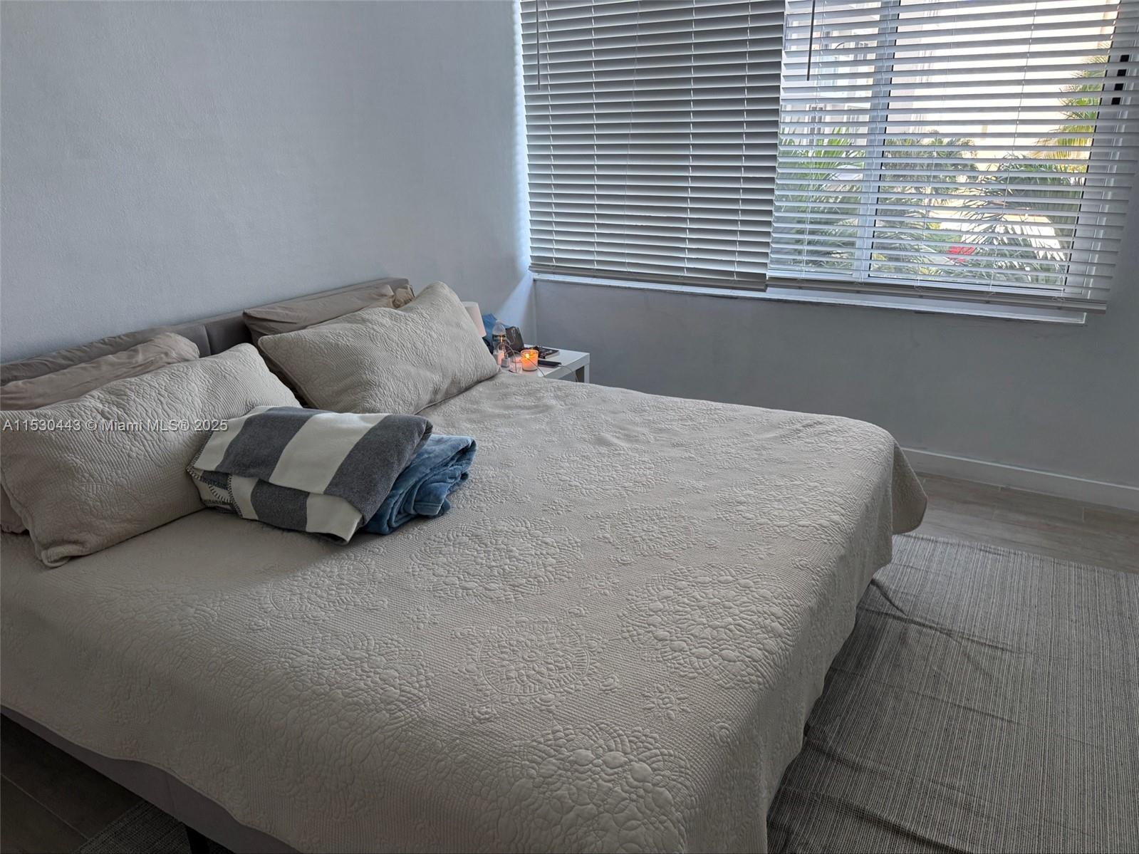 1200 West Avenue, Unit 202 Miami Beach, FL 33139 - Photo 41 of 45 a bed sitting in a bedroom next to a window