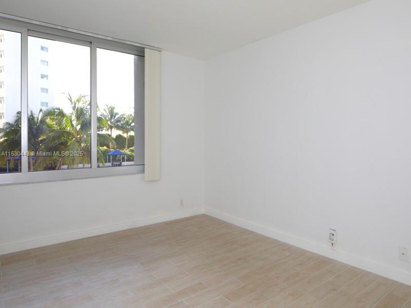 1200 West Avenue, Unit 202 Miami Beach, FL 33139 - Photo 42 of 45 an empty room with a window