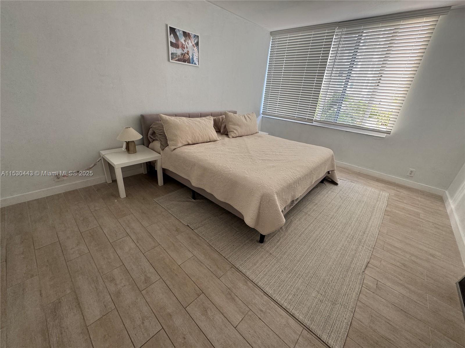 1200 West Avenue, Unit 202 Miami Beach, FL 33139 - Photo 6 of 45 a bedroom with a bed and a window