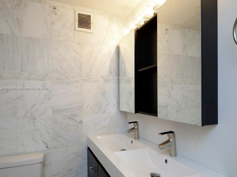 1200 West Avenue, Unit 202 Miami Beach, FL 33139 - Photo 9 of 45 a bathroom with a sink and a tub