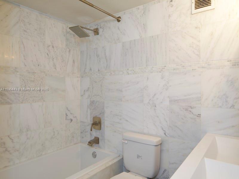 1200 West Avenue, Unit 202 Miami Beach, FL 33139 - Photo 10 of 45 a bathroom with a bathtub and a toilet