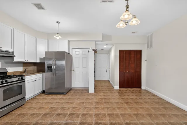 a kitchen with stainless steel appliances a refrigerator and microwave