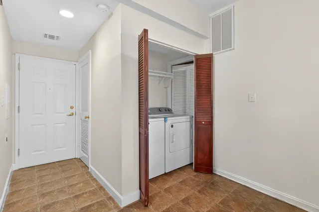 an empty room with closet and wooden floor