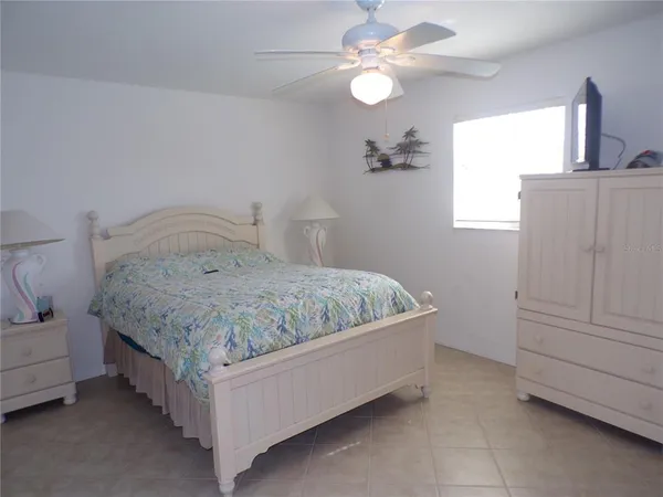 a bedroom with a bed and cabinet