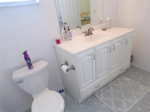 a bathroom with a sink mirror vanity and toilet