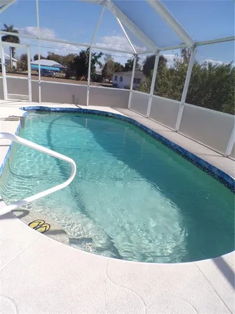 a view of a backyard with swimming pool