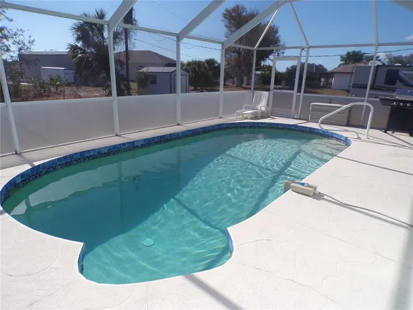 a view of a swimming pool with a yard