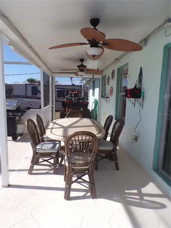 a dining room with furniture a chandelier and window