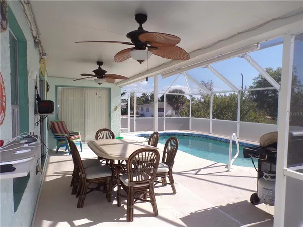 a view of a chairs and table in the balcony