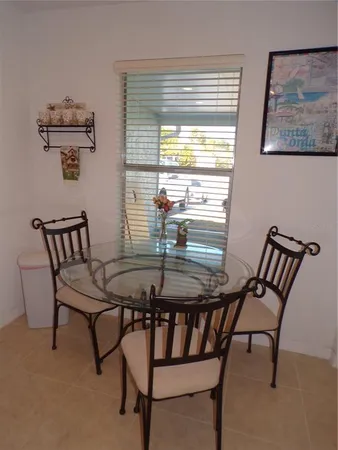 a view of a dining room with furniture and window