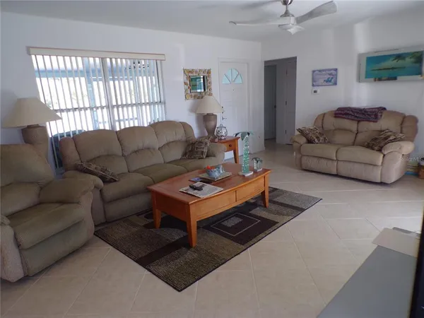 a living room with furniture a table and a window