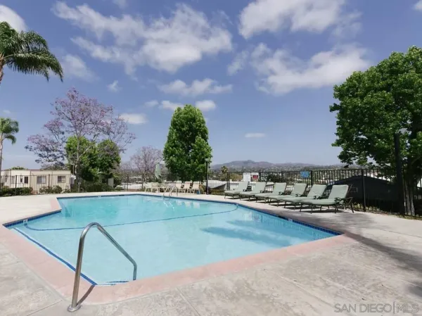 a view of swimming pool with outdoor seating and plants