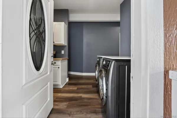 a view of a storage and utility room with washer and dryer