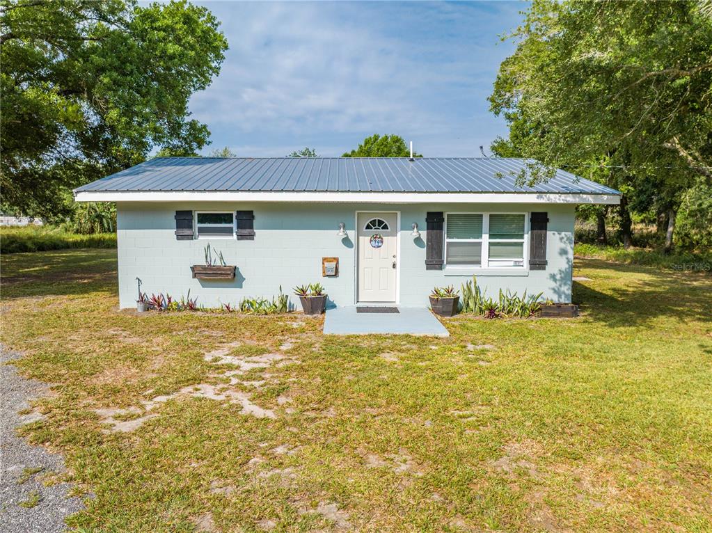 150 North Post Road Kenansville, FL 34739 - Photo 1 of 42 a front view of a house with a yard