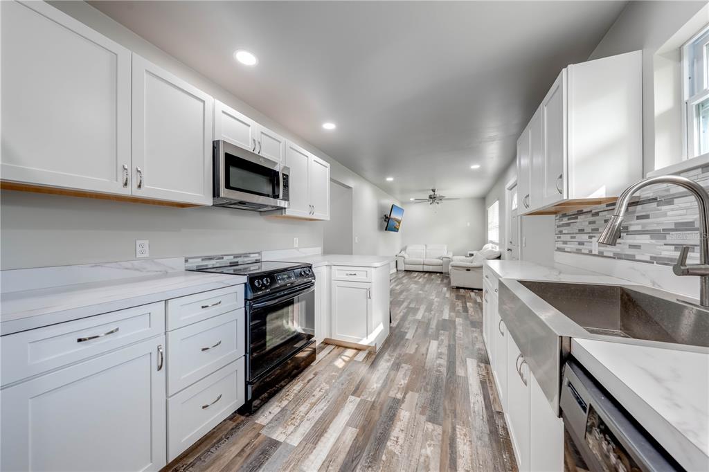 150 North Post Road Kenansville, FL 34739 - Photo 15 of 42 a kitchen with sink cabinets and stainless steel appliances