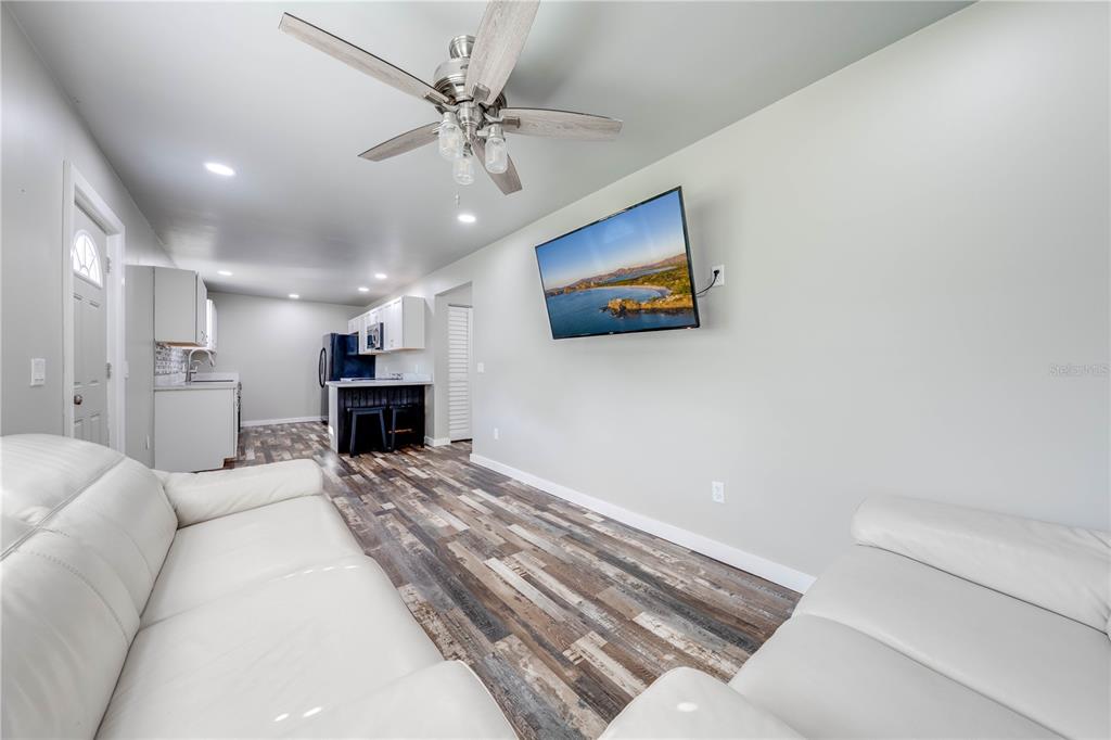 150 North Post Road Kenansville, FL 34739 - Photo 19 of 42 a living room with furniture and a flat screen tv