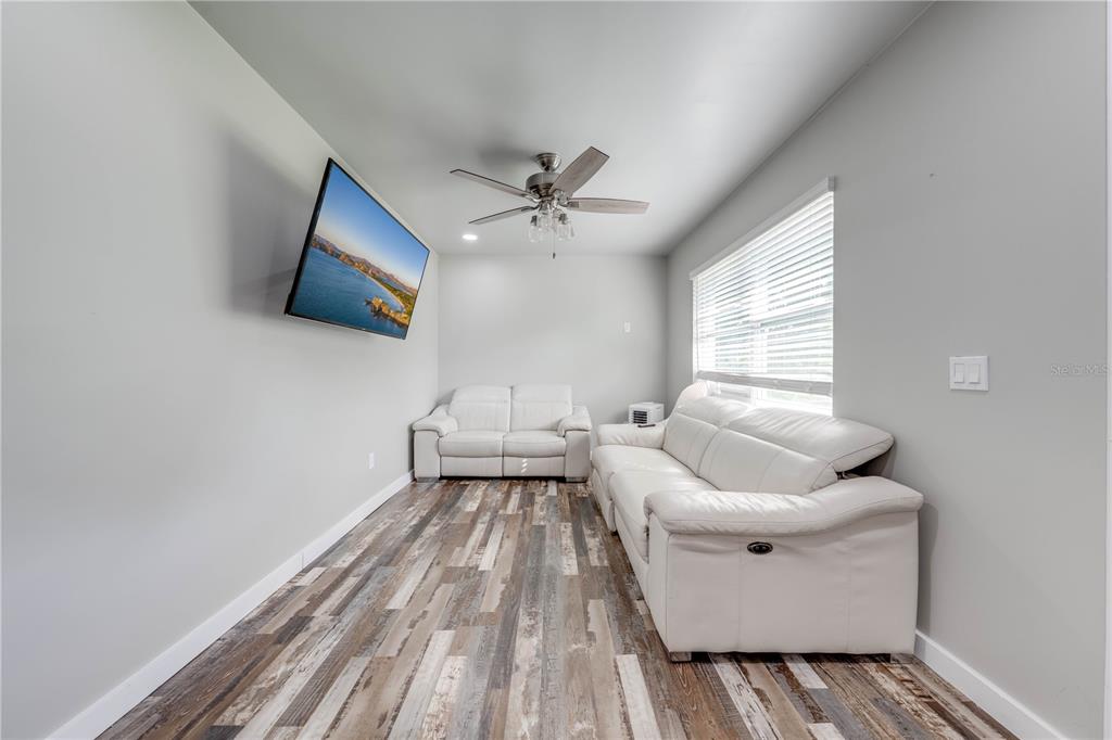 150 North Post Road Kenansville, FL 34739 - Photo 20 of 42 a living room with furniture and a flat screen tv