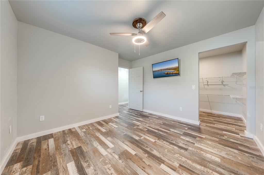 150 North Post Road Kenansville, FL 34739 - Photo 26 of 42 a view of an empty room with wooden floor and a ceiling fan