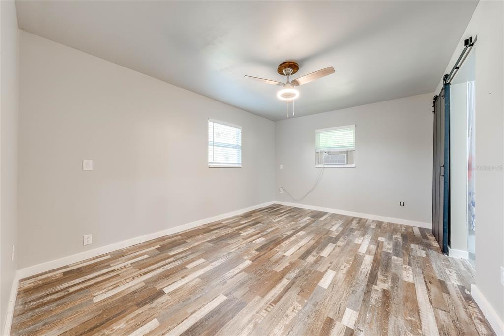150 North Post Road Kenansville, FL 34739 - Photo 28 of 42 a view of empty room with wooden floor and fan