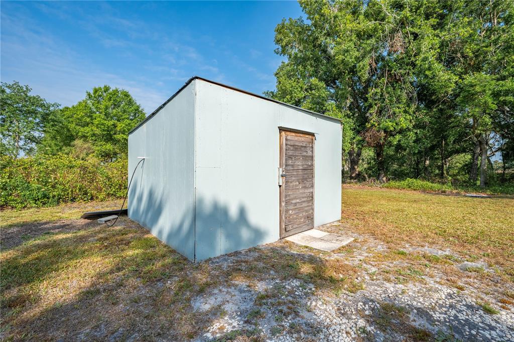 150 North Post Road Kenansville, FL 34739 - Photo 33 of 42 a view of backyard with large trees