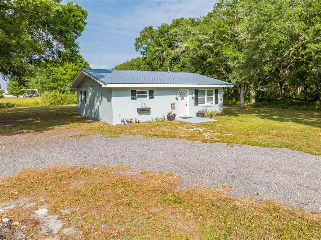 150 North Post Road Kenansville, FL 34739 - Photo 7 of 42 a view of a house with pool and yard
