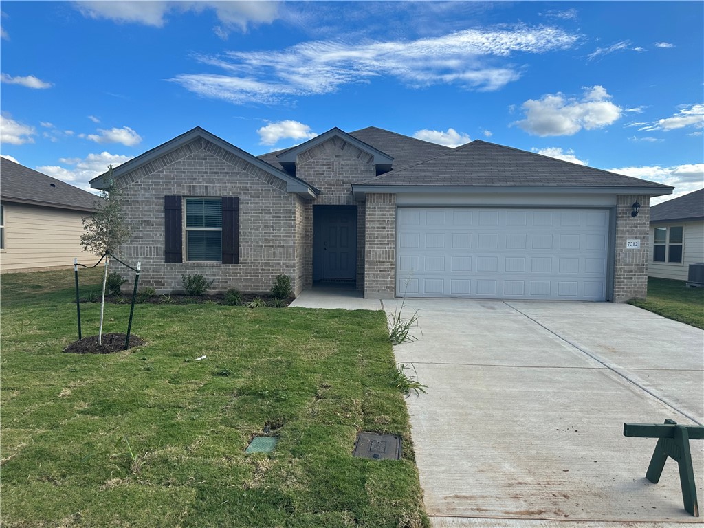 7012 Canadian Drive China Spring, TX 76633 - Photo 1 of 1 a front view of house with a garden