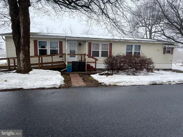a view of house with backyard and sitting area