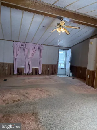 a view of a livingroom with furniture and chandelier fan