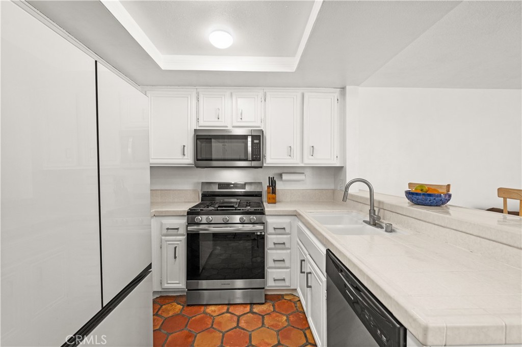 16 Wellesley, Unit 2 Irvine, CA 92612 - Photo 16 of 55 a kitchen with a sink appliances and cabinets