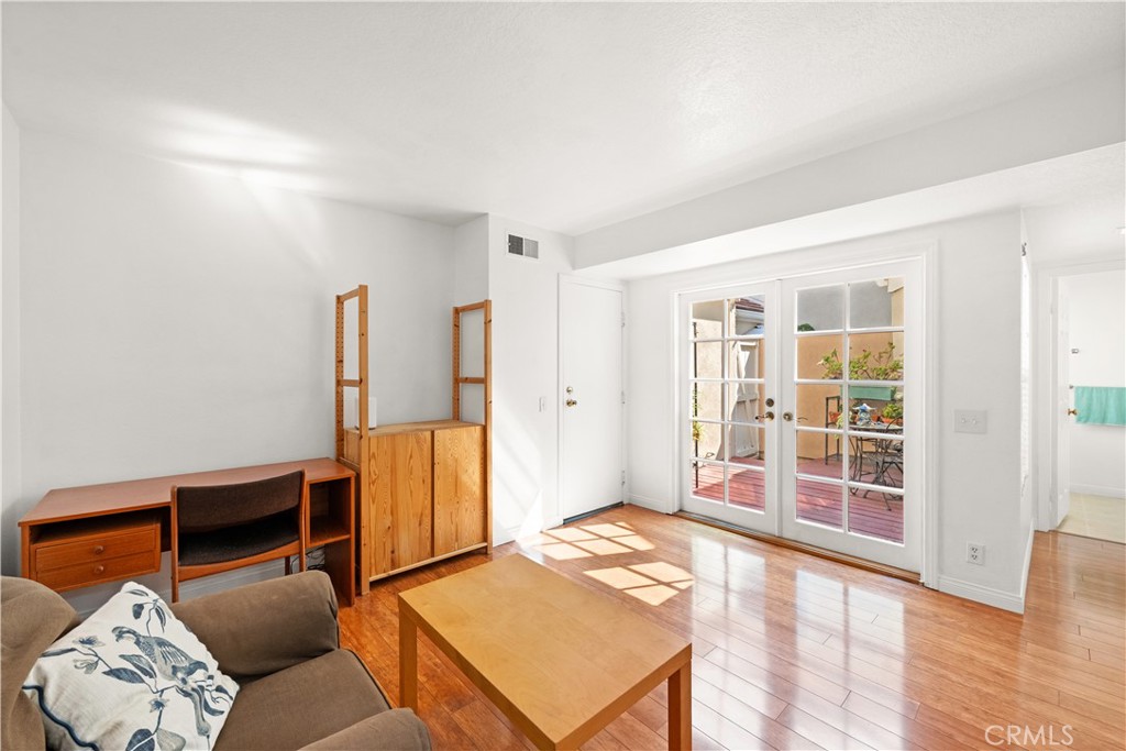 16 Wellesley, Unit 2 Irvine, CA 92612 - Photo 21 of 55 a living room with furniture window and wooden floor