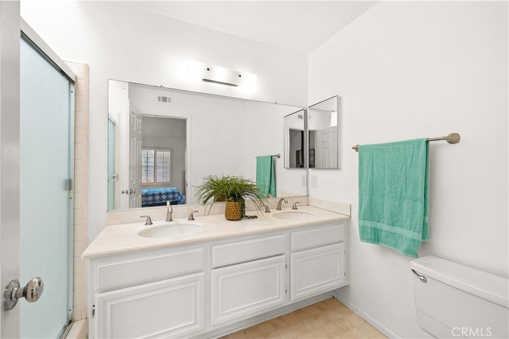 16 Wellesley, Unit 2 Irvine, CA 92612 - Photo 34 of 55 a bathroom with a double vanity sink mirror and bathtub