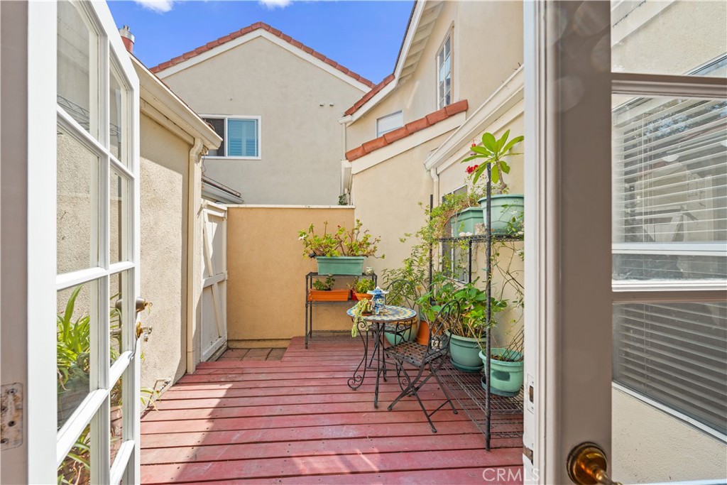 16 Wellesley, Unit 2 Irvine, CA 92612 - Photo 36 of 55 a view of a balcony with chairs and wooden floor