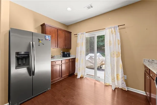 a kitchen with stainless steel appliances granite countertop a refrigerator and a sink