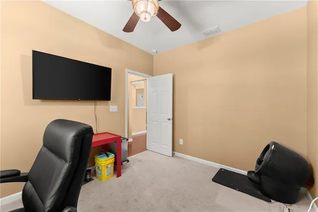 a bedroom with a chair and a flat screen tv