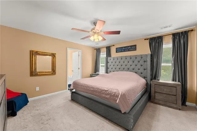 a bed sitting in a bedroom next to a window