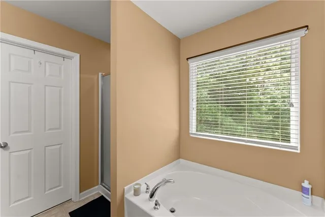 a bathroom with a bathtub and a window