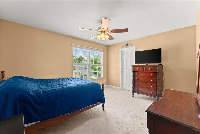 a bedroom with a bed and a television