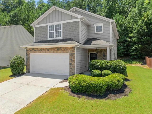 a front view of a house with garden