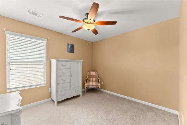 a view of room with cabinet and ceiling fan