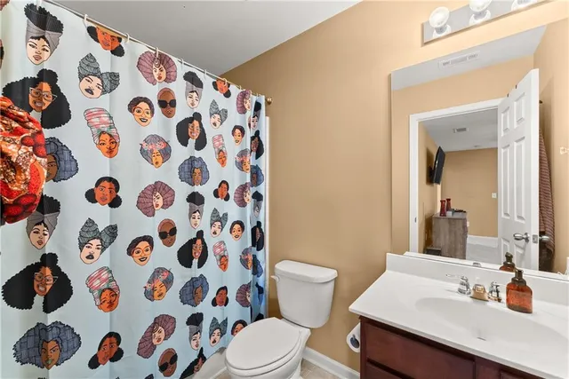 a bathroom with a sink and mirror with toilet