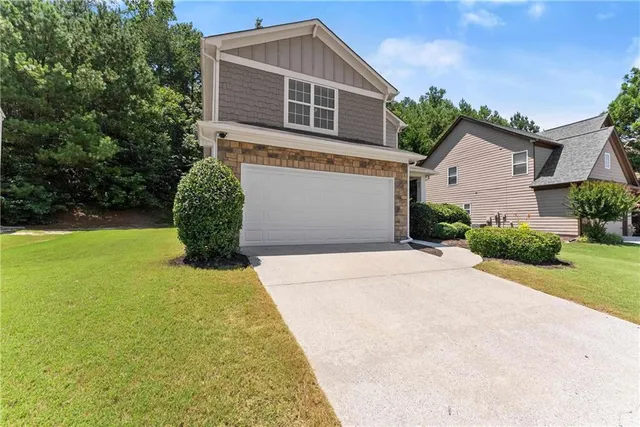a front view of a house with garden