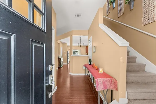 a view of entryway and hall with wooden floor