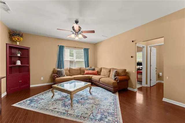 a living room with furniture a rug and a window