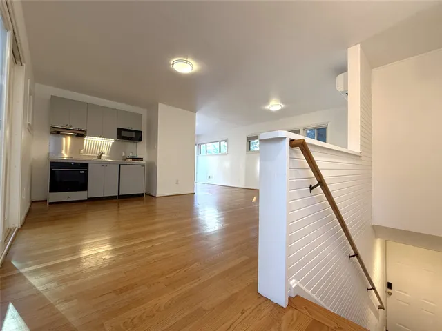 a view of a kitchen with furniture and wooden floor