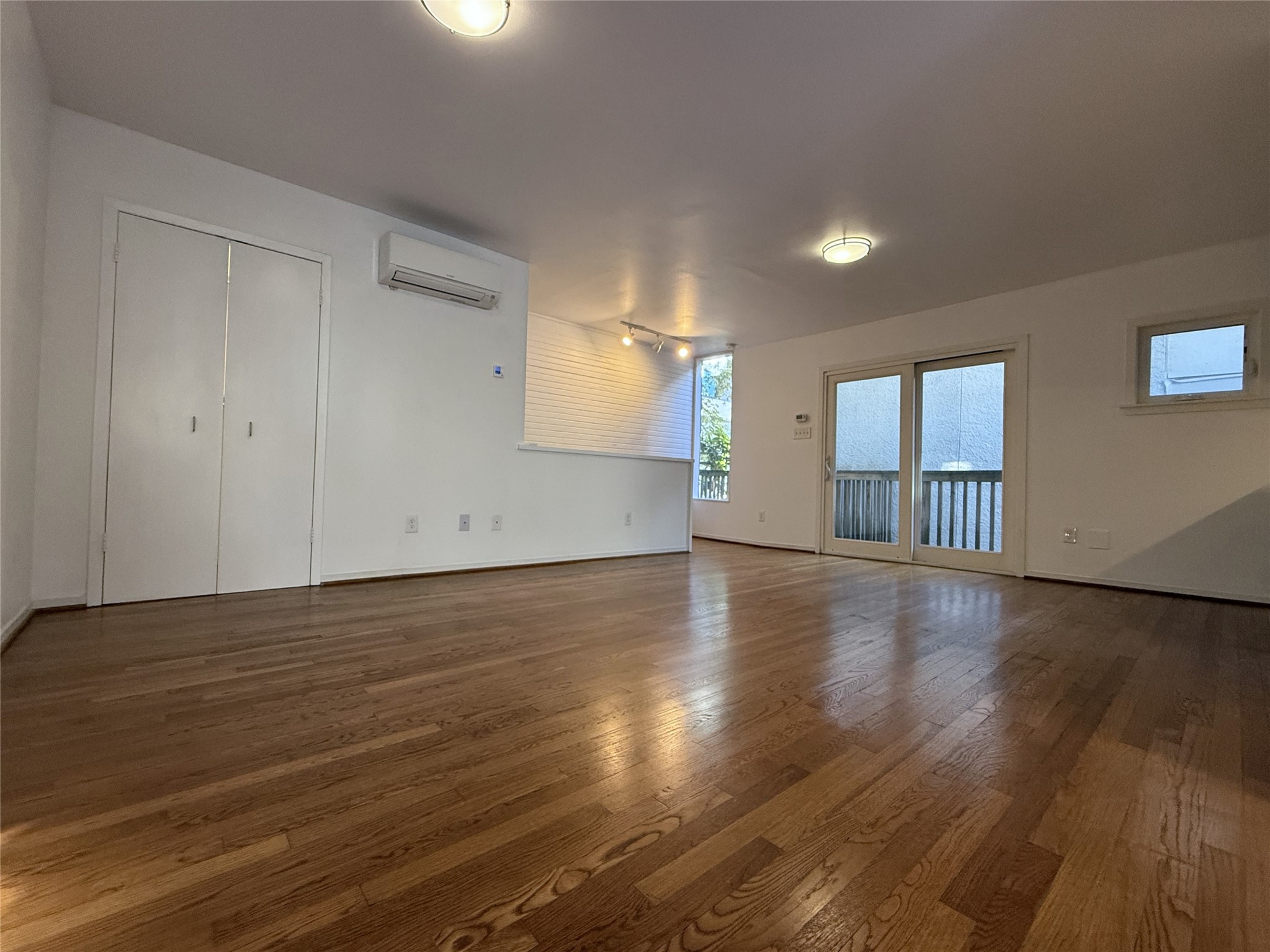 2721 Kipling Street, Unit D Houston, TX 77098 - Photo 5 of 15 a view of an empty room with wooden floor and fan