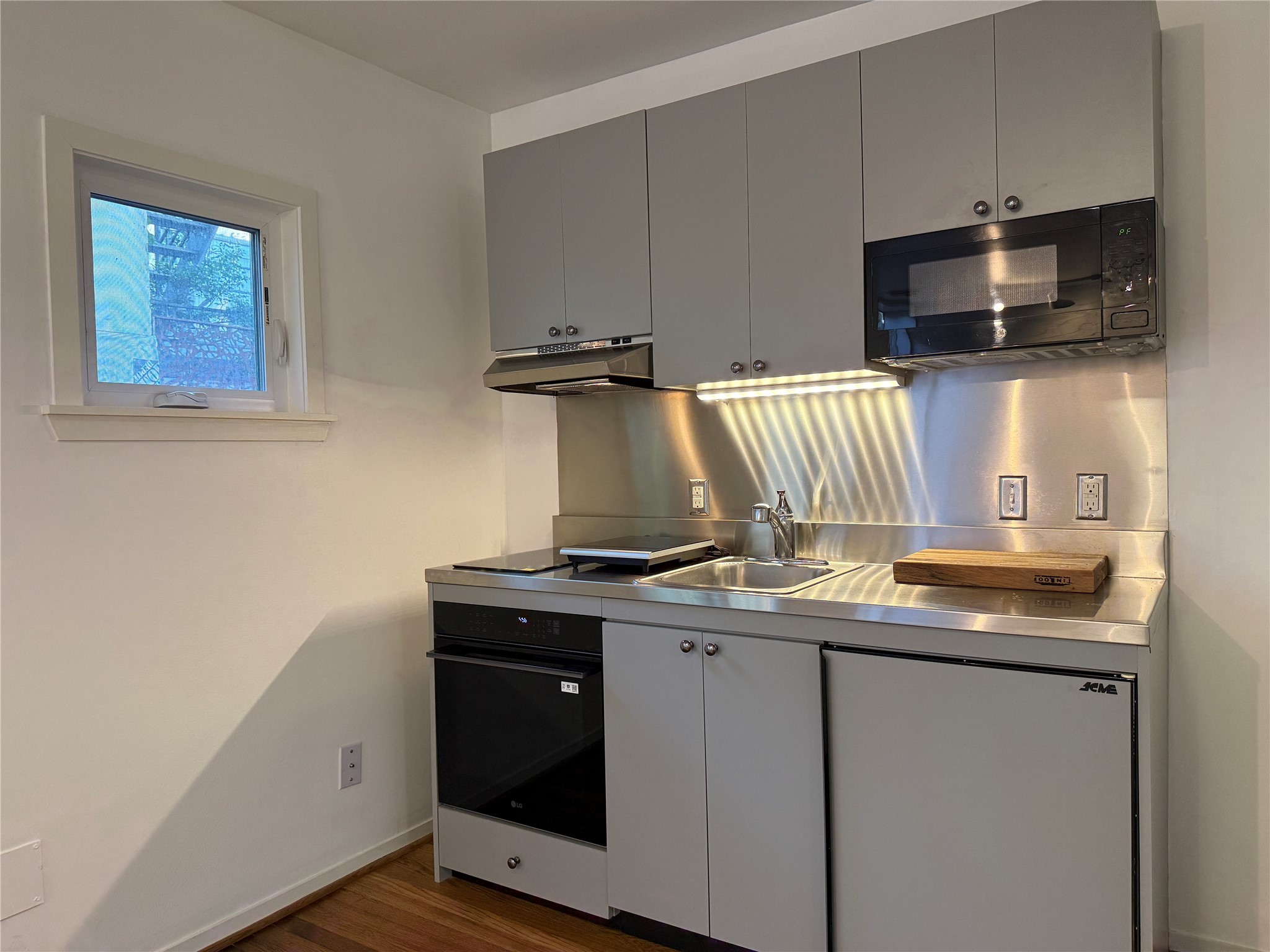 2721 Kipling Street, Unit D Houston, TX 77098 - Photo 7 of 15 a kitchen with stainless steel appliances granite countertop a sink and a microwave