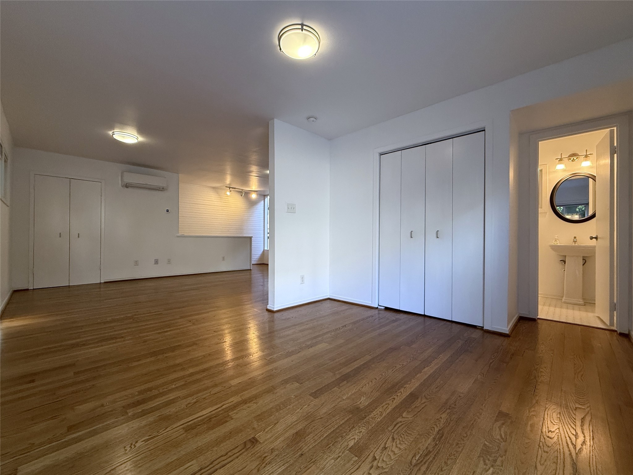 2721 Kipling Street, Unit D Houston, TX 77098 - Photo 10 of 15 an empty room with wooden floor and windows